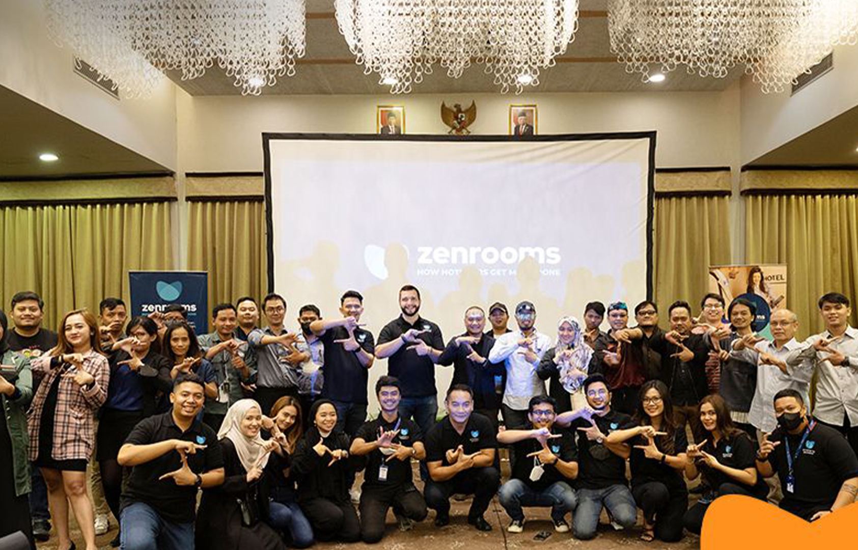 A group of business people in a room celebrating a new achievement together with startup branding designed and created by Gohan Strategy.